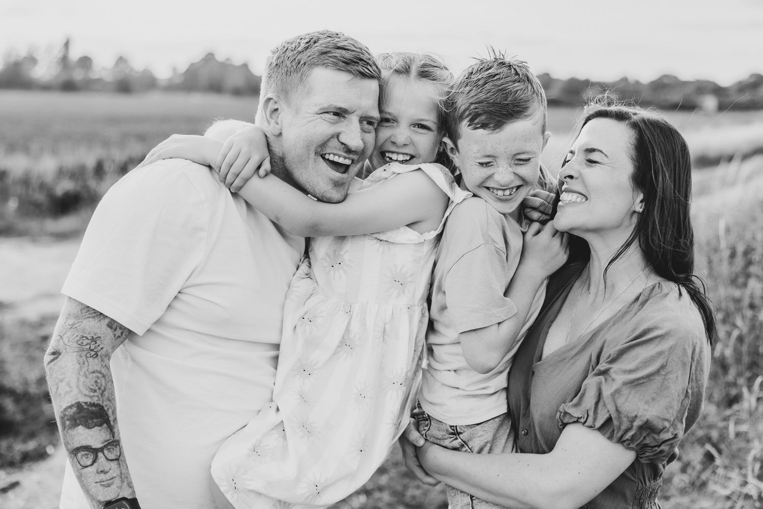 Family sharing joyful moment together on windswept beach.