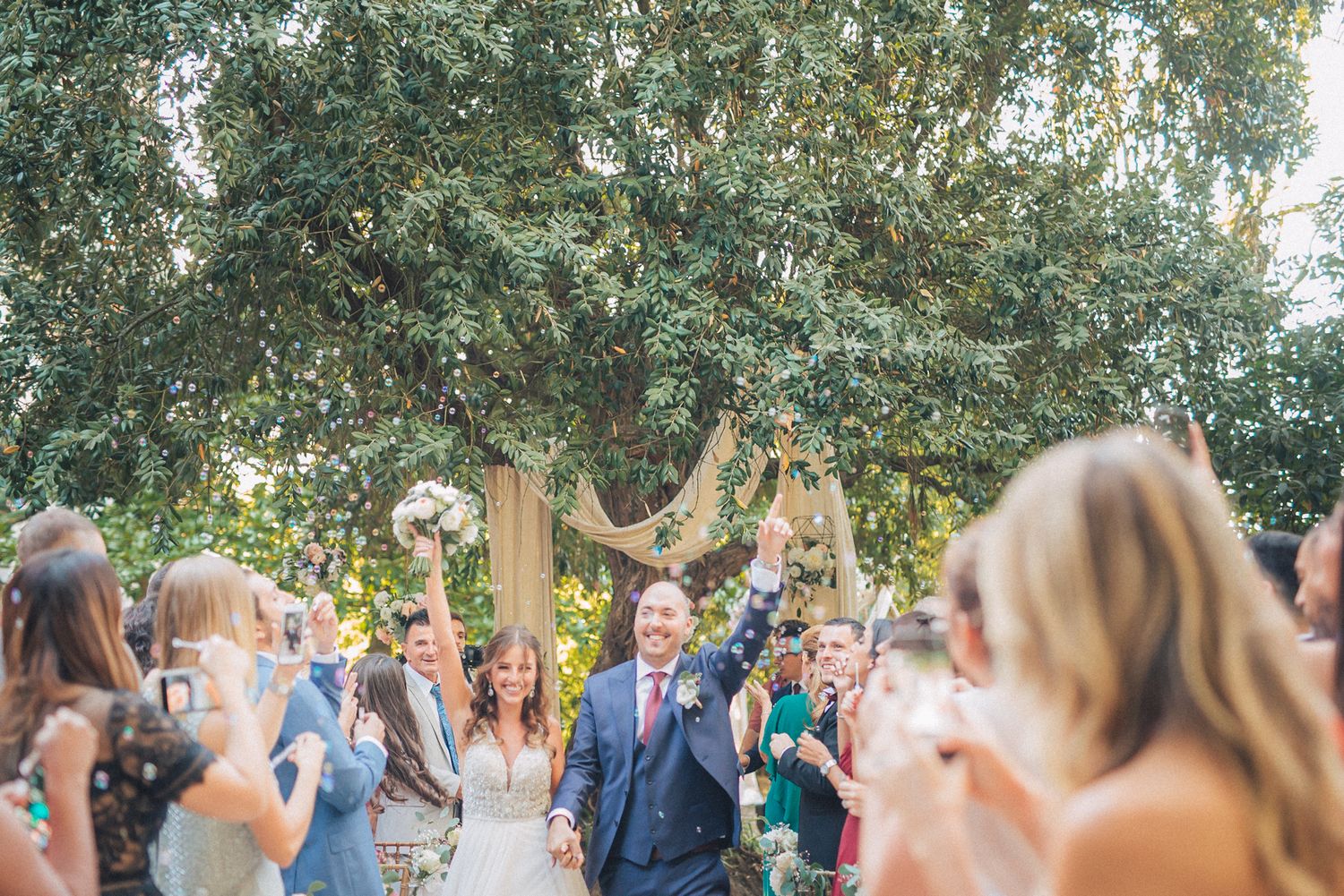Wedding ceremony guests and newlyweds celebrate at casa dos penedos in Sintra. captured by a destination wedding photographer in Portugal