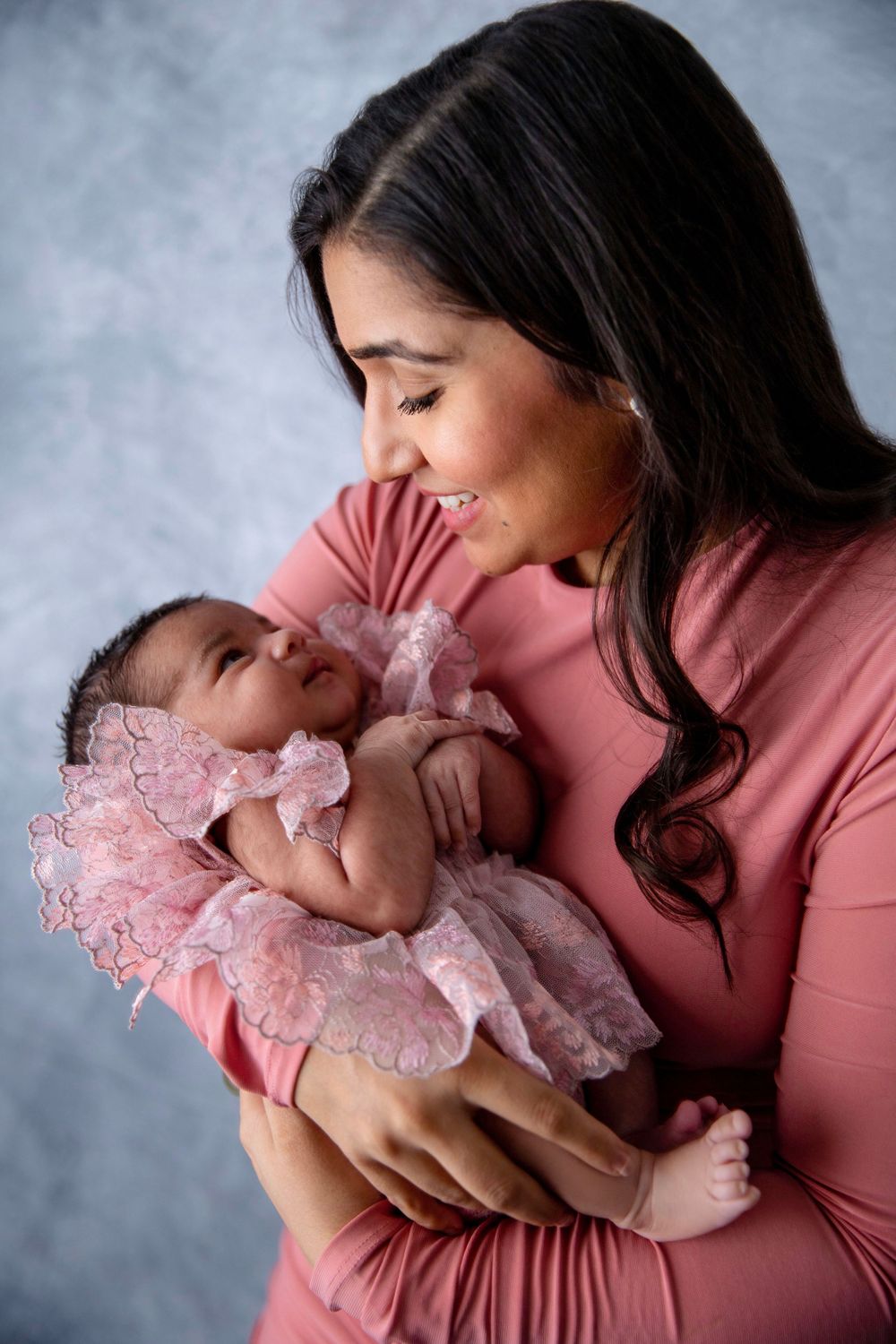 Mother holding newborn baby girl during Central Florida newborn photography session.