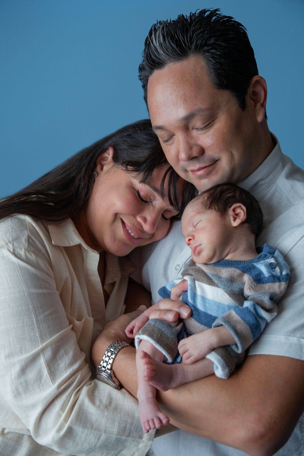 Parents holding newborn baby during family newborn photography session in Orange City Florida.