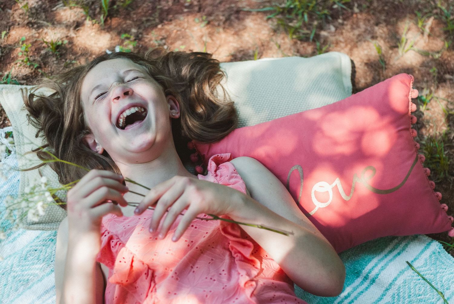 Young girl laughing at a picnic themed mini session in Fort Mill, South Carolina