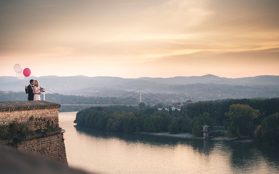 Fotografija mladenaca na Petrovaradinskoj tvrđavi pokraj Novog Sada 
Mladenci sa balonima u zalasku - odlasku sunca