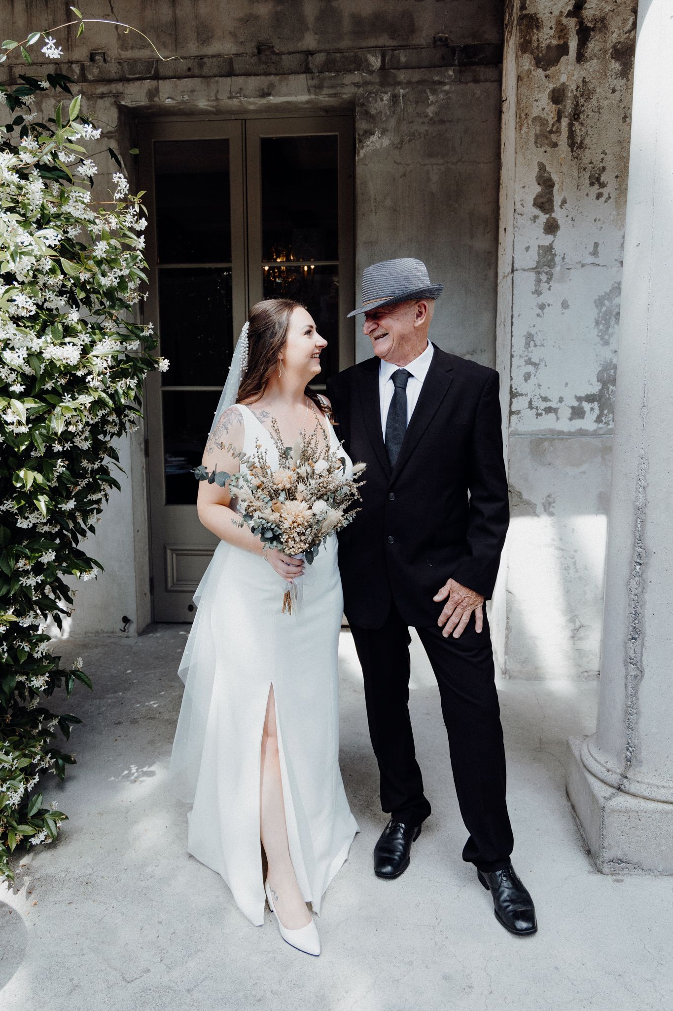 A bride in a white dress and her father share a moment photo by Apertured Media Auckland Wedding Photographer