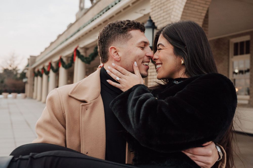 Couple taking engagement photo shoot in Central PA at the Hershey Hotel in Hershey PA