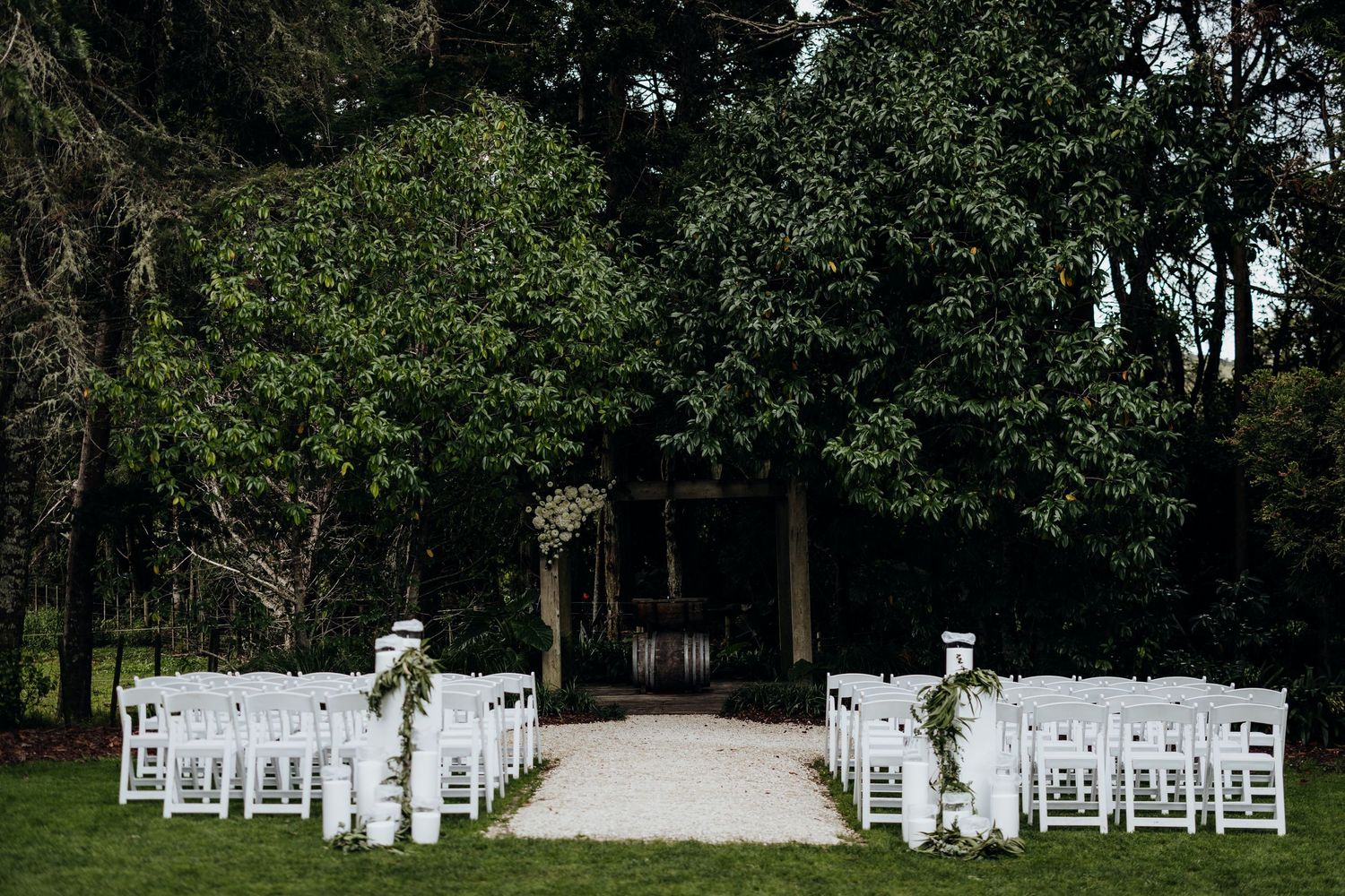 Four artistic engagement photos show a couple posing between white stone columns at a historic landmark building.