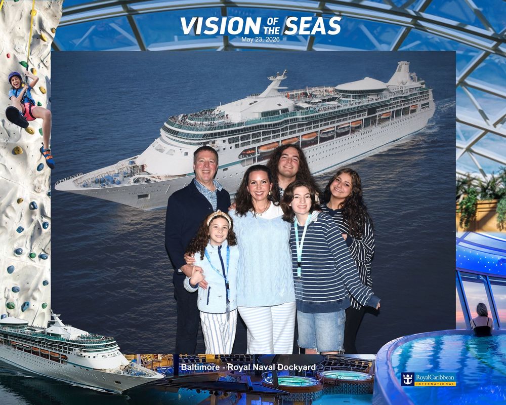 Family posing in front of Vision of the Seas cruise ship photo backdrop at Royal Naval Dockyard Baltimore.
