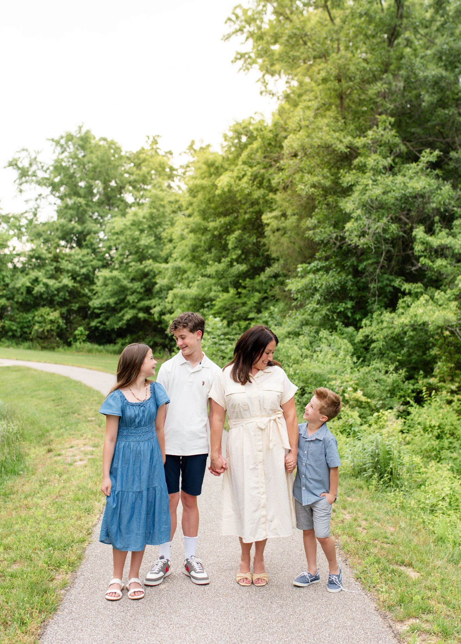 Family walking together during outdoor sunset session in O’Fallon Missouri