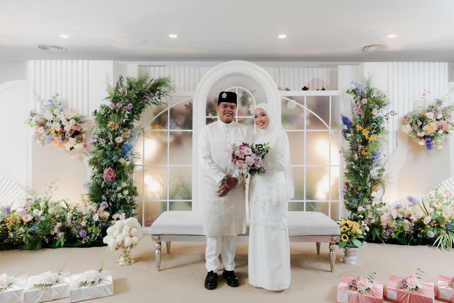 Wedding celebration in a bright greenhouse with natural lighting and hanging plants.