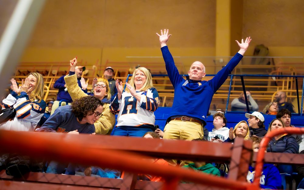 Hershey Trojans hockey fans celebrating a goal in the stands at the Bears Cup, by Deanna Fox, SportsFox Photography, Hershey PA