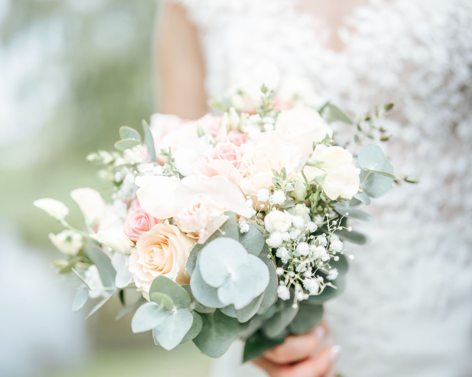 Close up photo of white flowers held by a bride.
