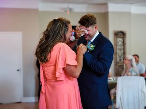 Several emotional moments captured between wedding guests in a series of candid photographs at an indoor venue.