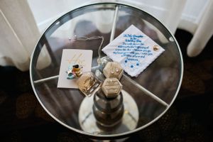 Wedding favors and decorative items arranged on a mirrored tray surface.