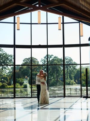 Three connected photos show a sunlit event space with floor-to-ceiling windows overlooking a scenic waterfront view.
