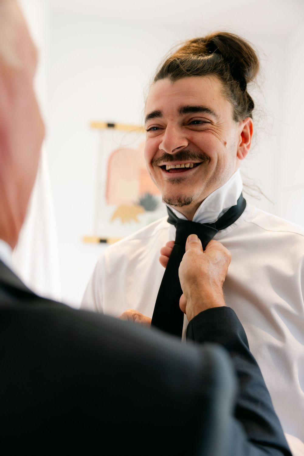 Candid sequence showing genuine laughter and joy during a formal indoor event.