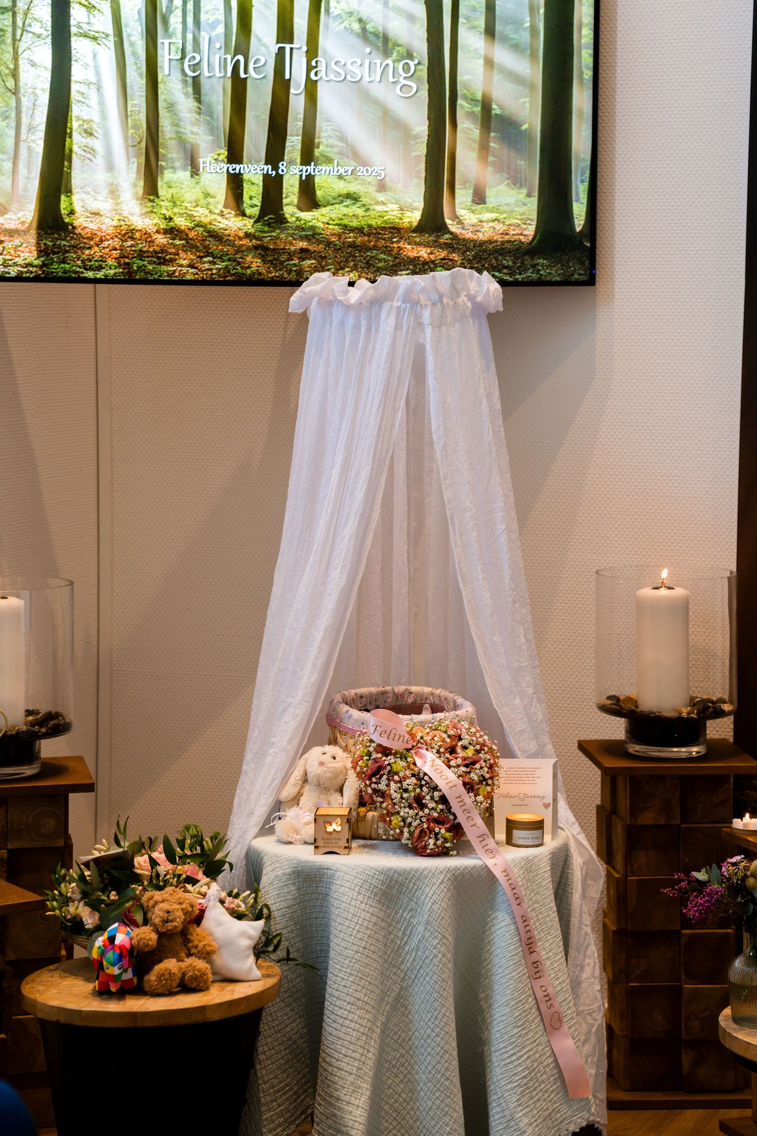 White canopy draped over a round table with decorative elements and candles in a cozy indoor setting.