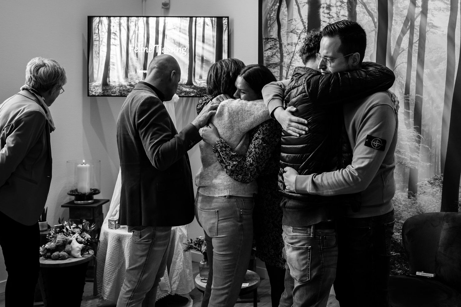 A black and white photo shows people standing in line at a voting booth during an election.