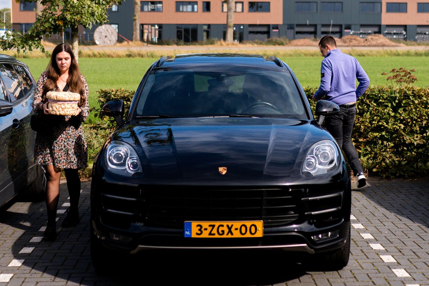 Luxury black Porsche Panamera parked in urban setting.