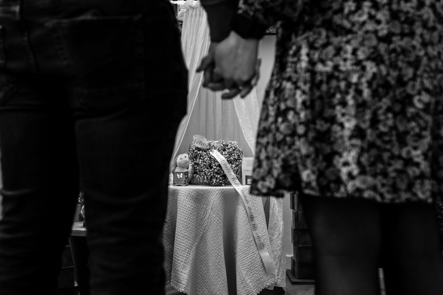 Dark silhouettes against patterned background in black and white.