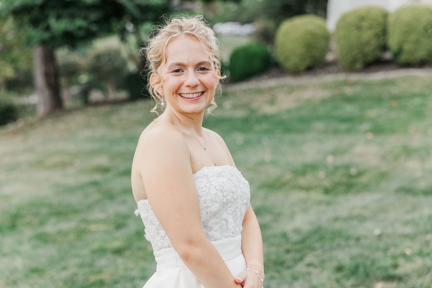 A joyful outdoor wedding moment against a natural landscape.