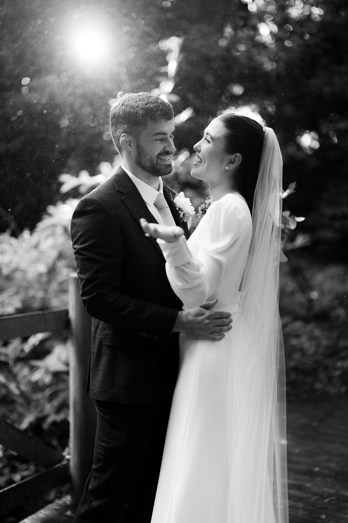 Black and white wedding portrait capturing intimate moment in natural outdoor setting. Ellingham Hall