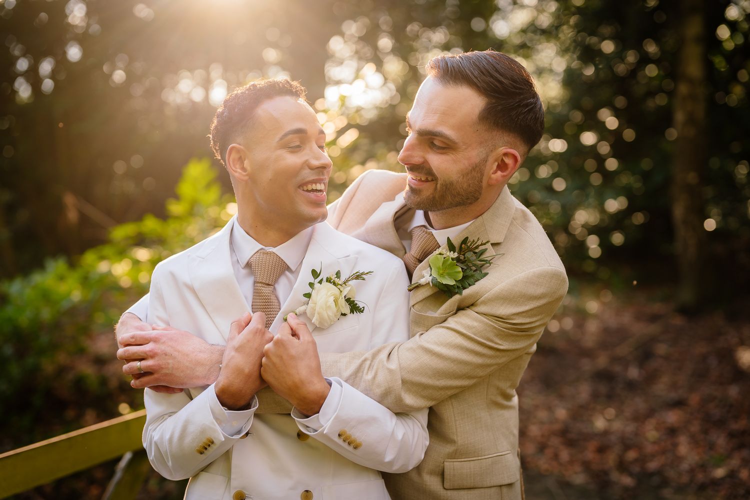 Romantic outdoor wedding photoshoot in golden sunlight through trees. Ellingham Hall