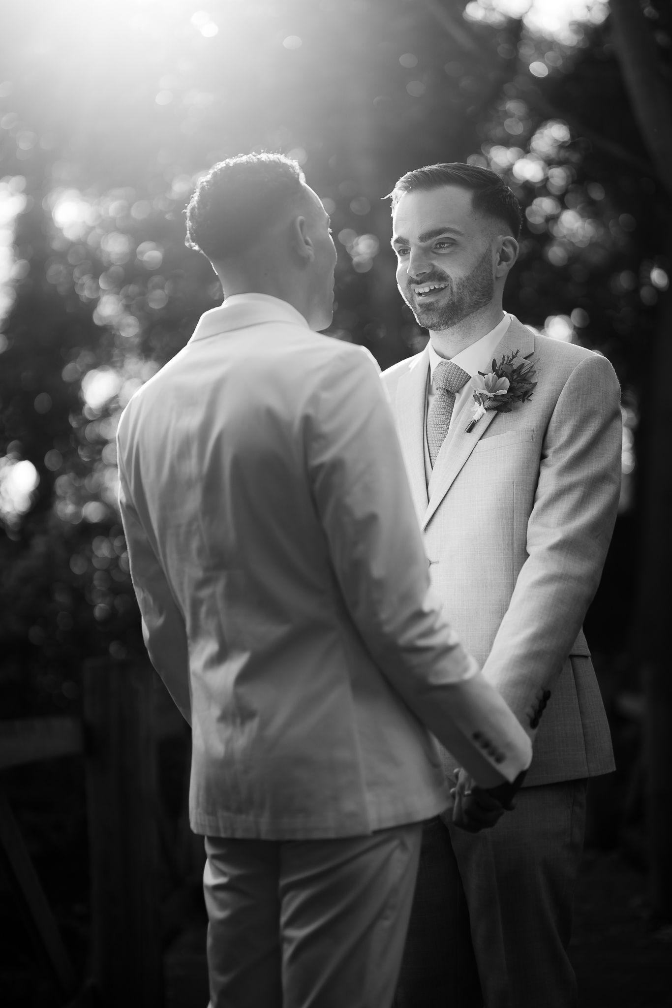 Black and white candid wedding moment captured in soft natural light. Ellingham Hall