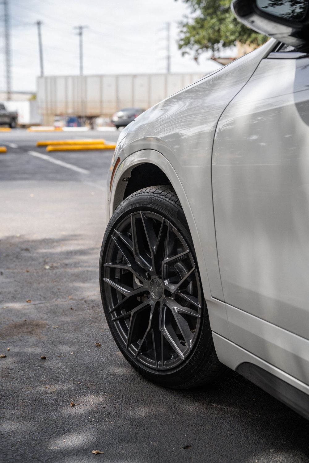 Close-up shots of a silver car with black alloy wheels from different angles showing wheel fitment and stance.
