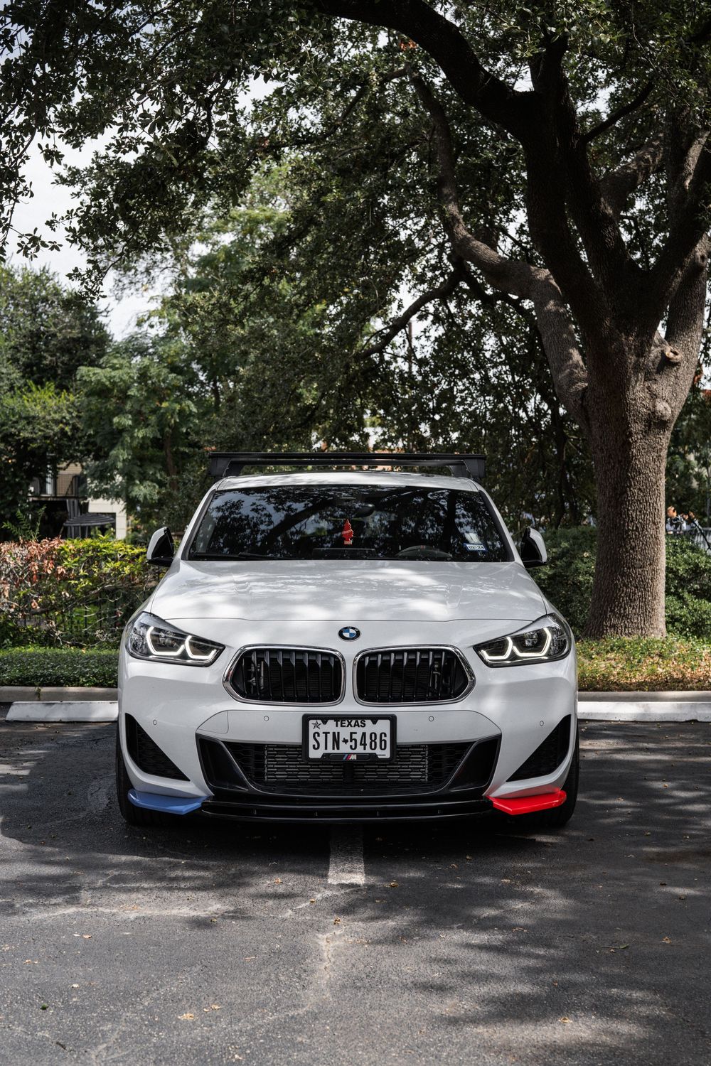 Front view of a white BMW M2 sports car showcasing its aggressive grille design and signature headlights.