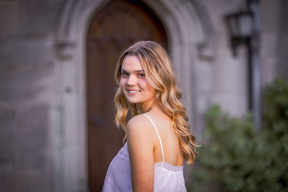 A series of six similar fashion portraits showing someone in a lavender dress against a stone wall backdrop.