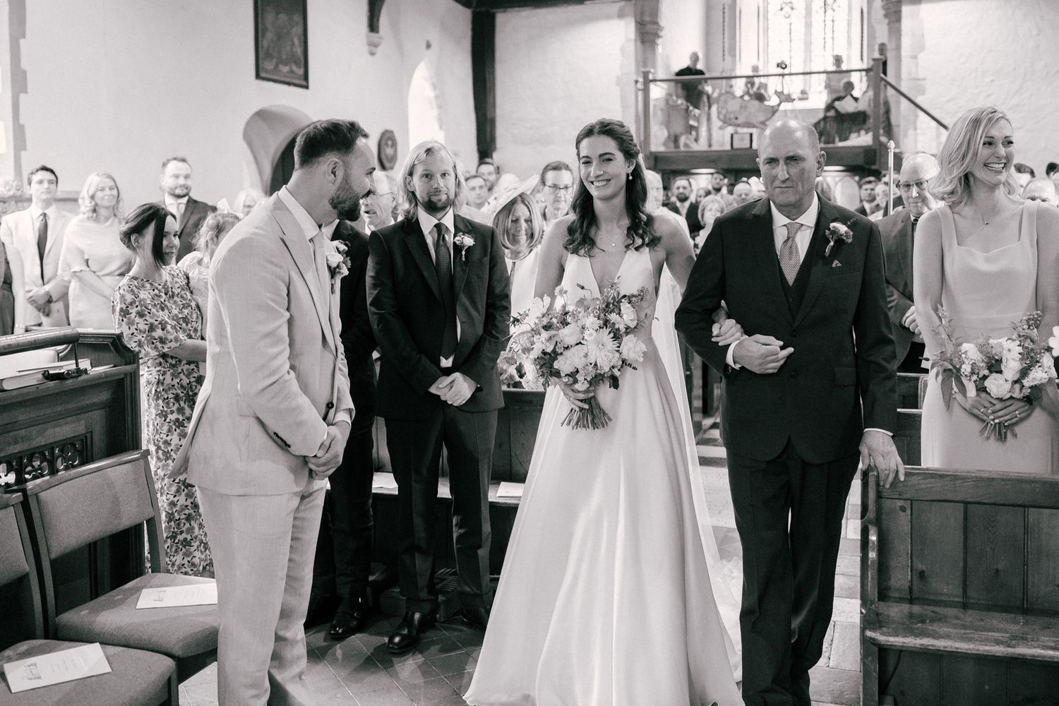 A series of black and white wedding photos showing ceremony and reception moments in a church setting.