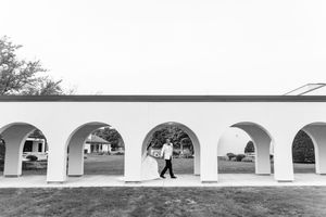 A series of black and white wedding photos displayed in a filmstrip style layout showing outdoor venue moments.