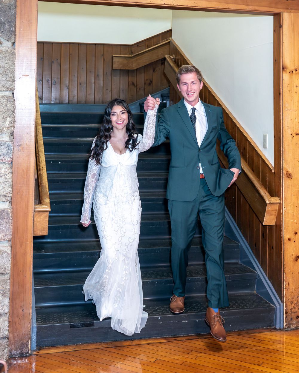 A couple in wedding attire descends a wooden staircase in a sequence of three connected photos.