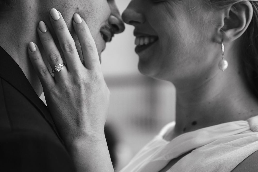 A black and white photo sequence shows a person covering their face with their hands in an emotional gesture.