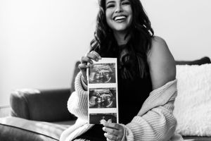 A sequence of black and white polaroid photos showing someone holding up photographs and smiling.