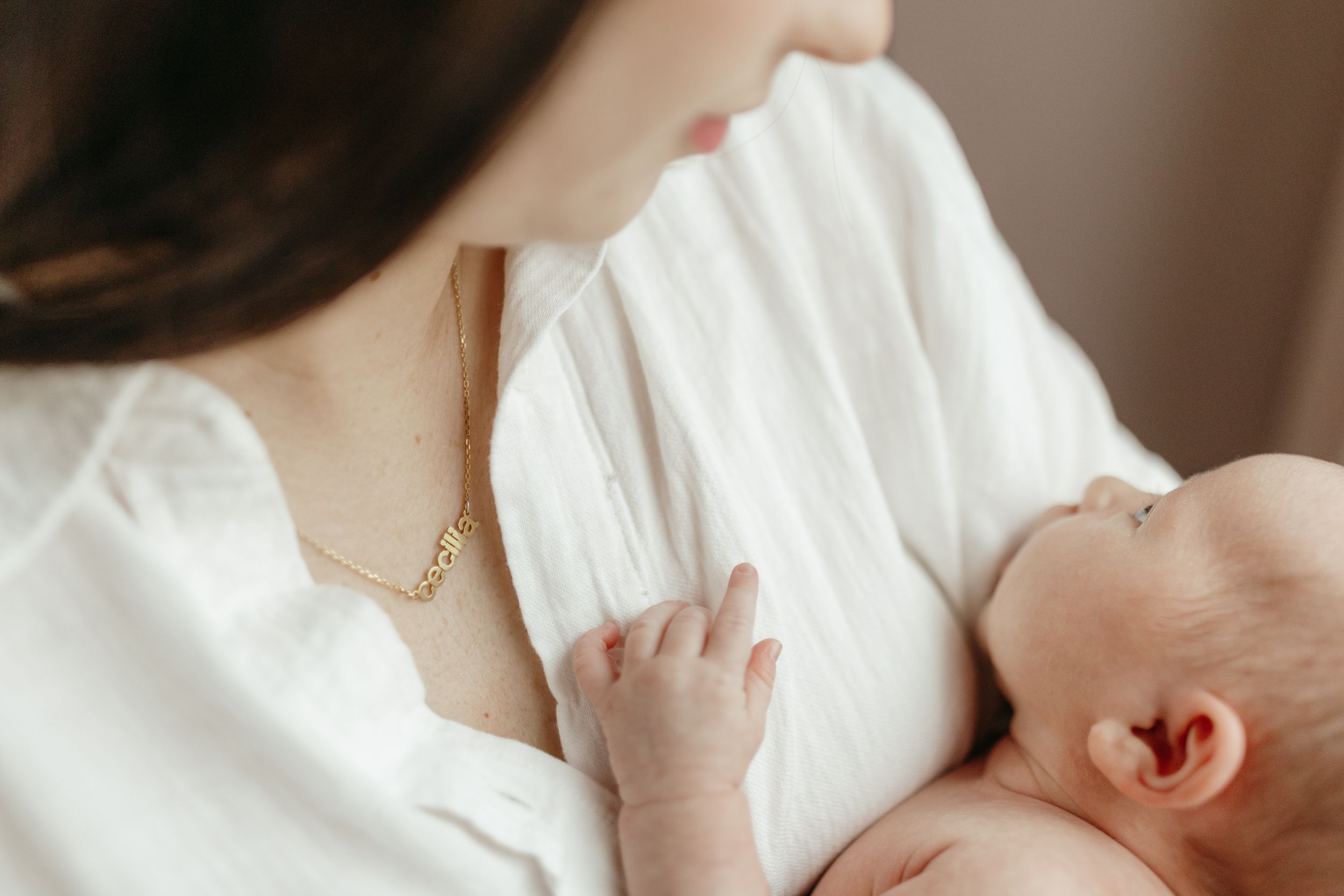 Tender moment of nurturing and bonding with a newborn.  Virginia/ North Carolina Newborn In-Home Session