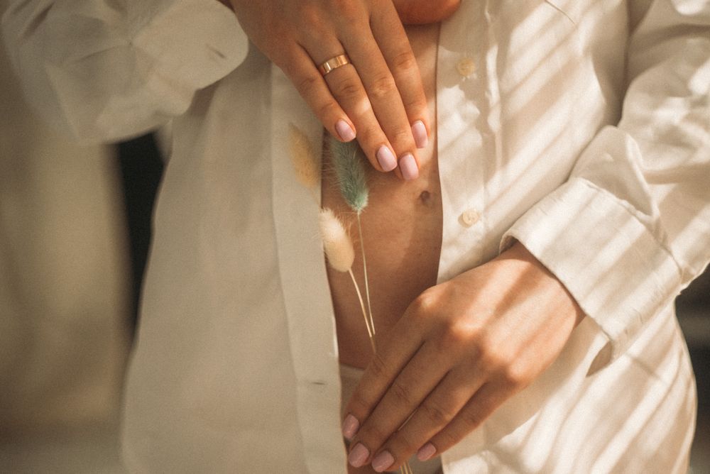 Close-up series of hands delicately touching white fabric in natural light.