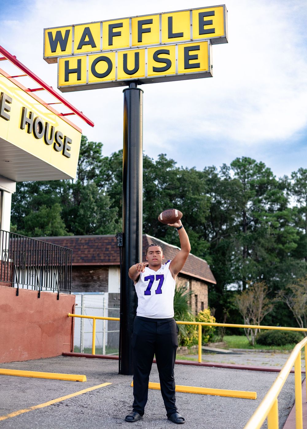 A person stands outside a Waffle House restaurant with yellow signage visible in multiple angles.