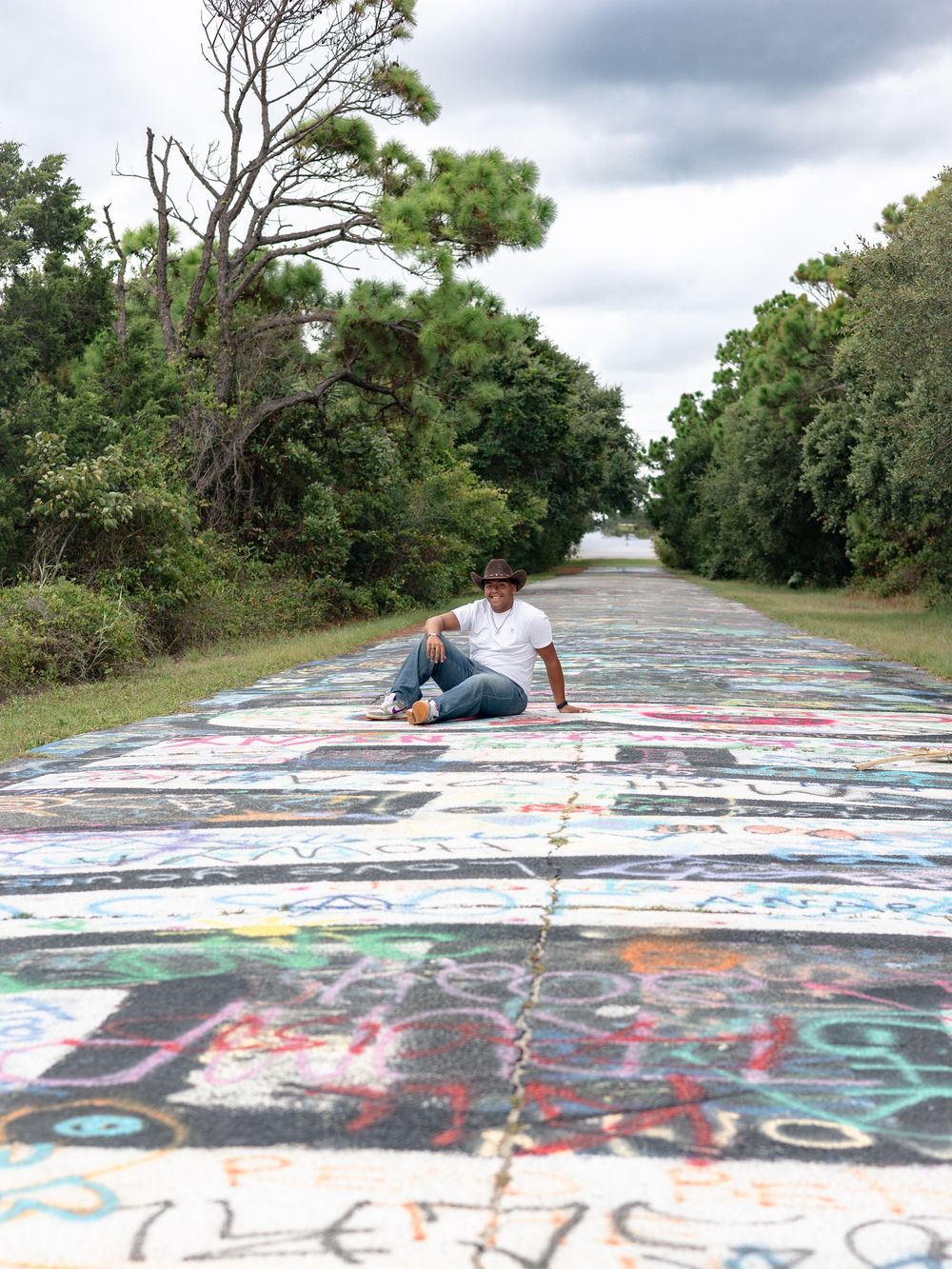 A graffiti-covered concrete surface with colorful street art and markings spread across multiple connected images.