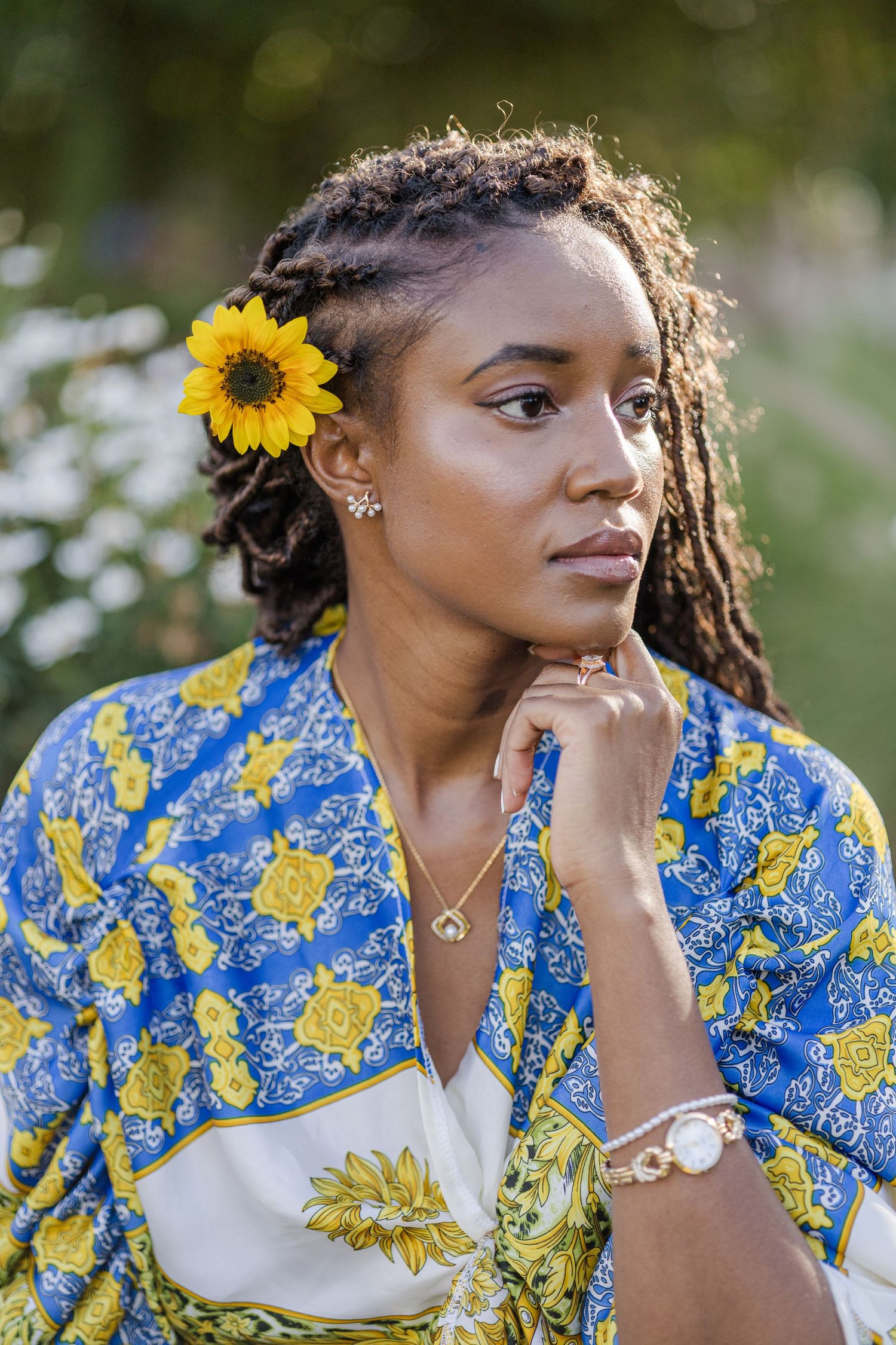 Portrait of a lady with a sunflower on her hair, with the glow of sunset on the left side of her face. Naishola. Ikigu George Photography.