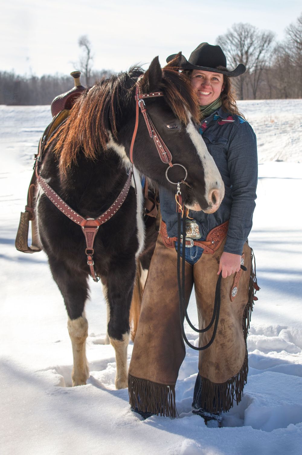 Cowgirl posing with her horse in a Wisconsin winter scen