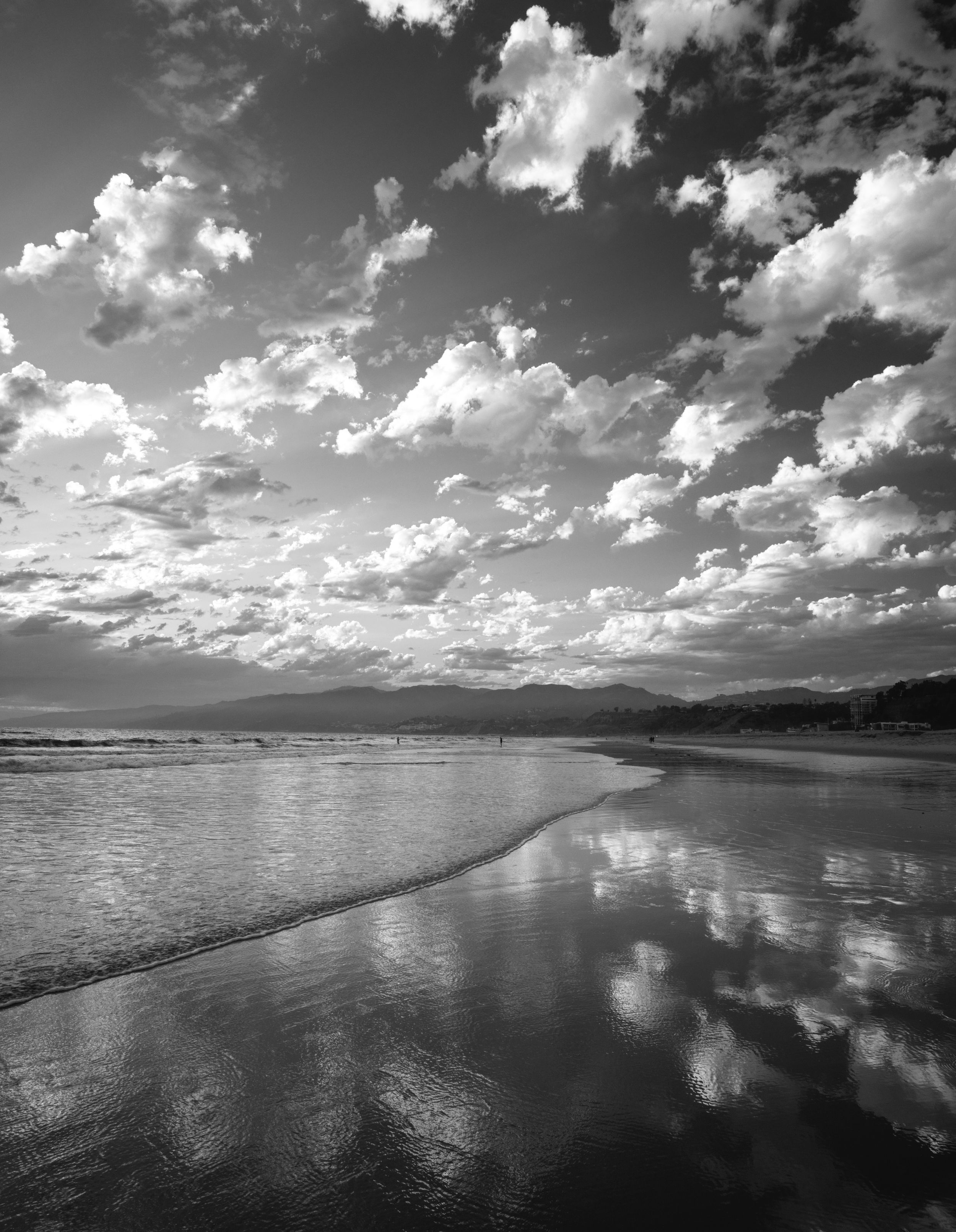 fine art landscape black and white photograph of sunset at Santa Monica beach California clouds reflected in the ocean on the beach wall art