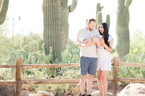 Newborn family portrait of 3 in front of the saguaro cacti at the Riparian Preserve in Gilbert, Arizona.