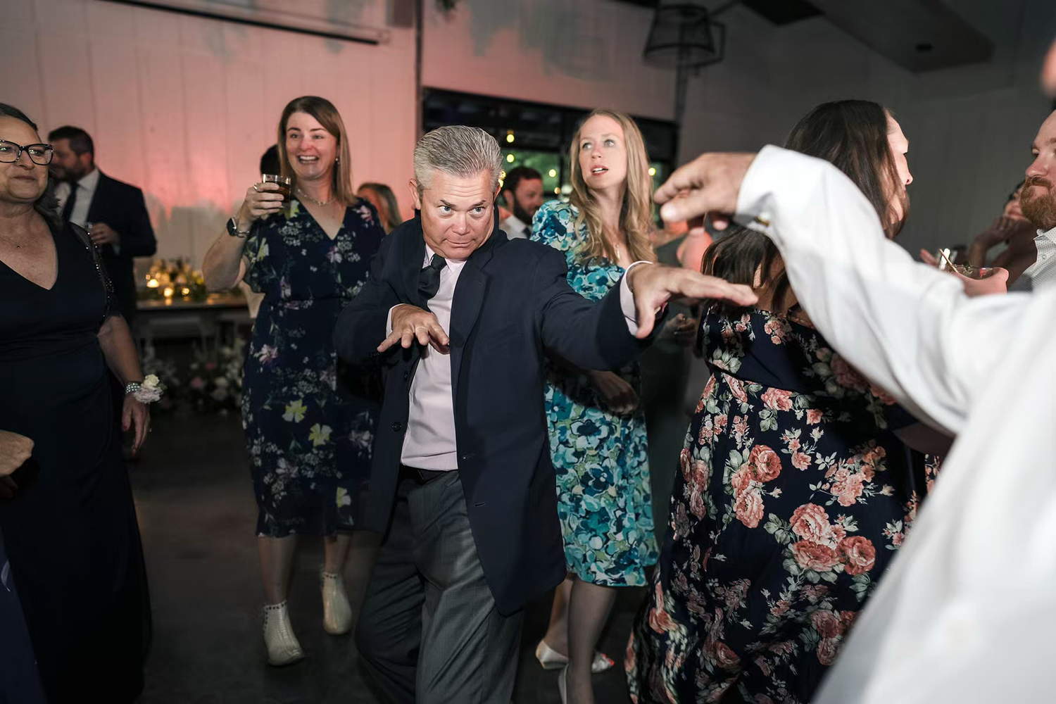 People dance together at a wedding reception in Retreat 21 Wedding Venue