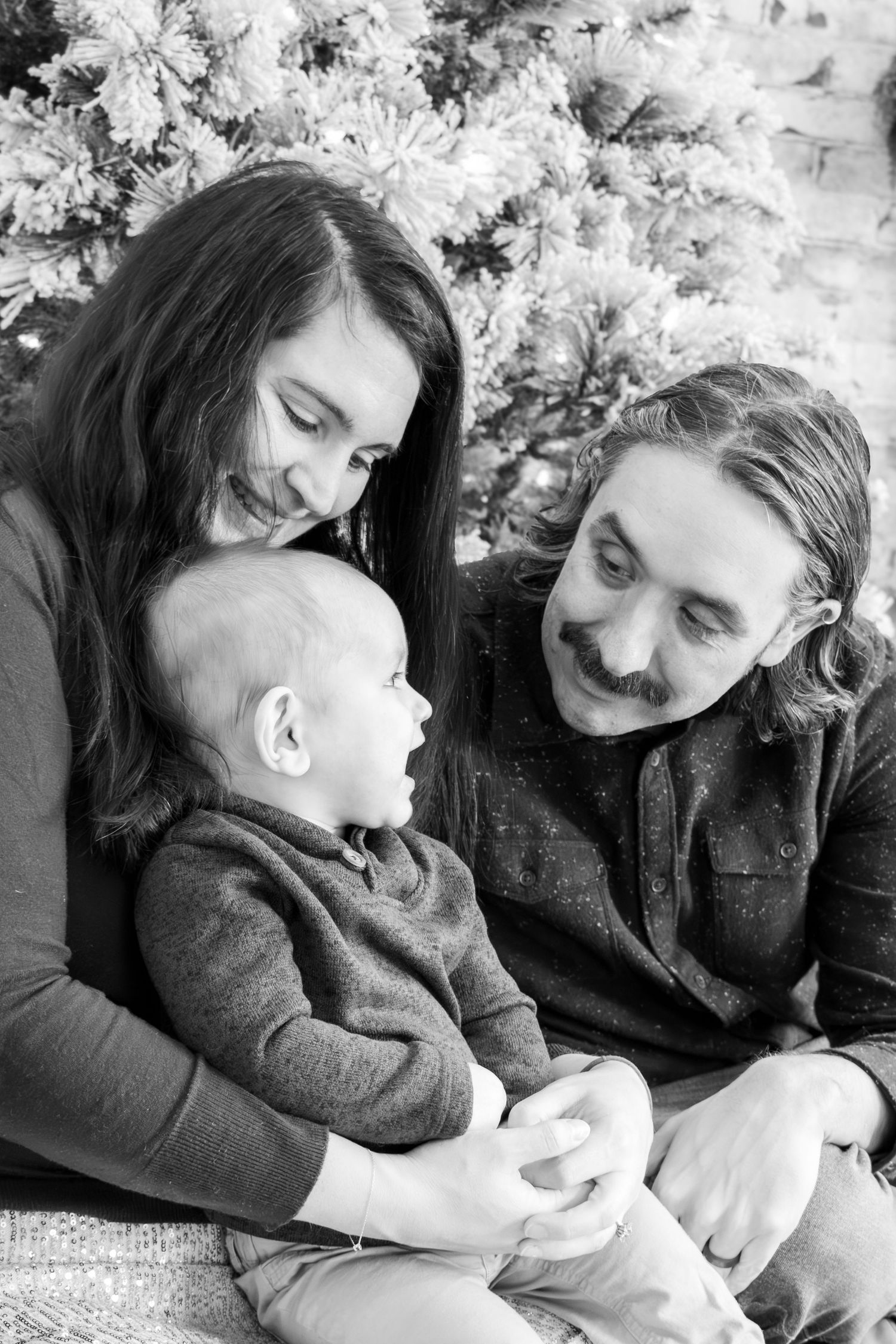Cincinnati Christmas mini session featuring mom dad and baby holiday portraits with festive decor, cozy studio lighting, and timeless family