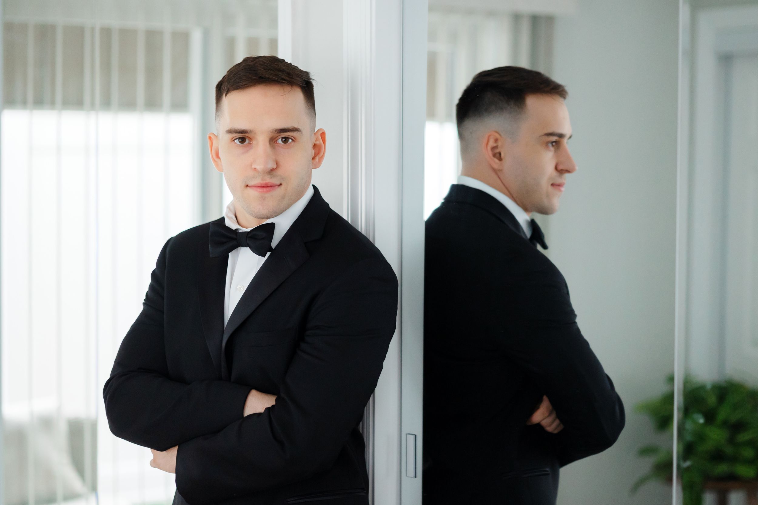 Groom beside mirror on wedding day in Ohio photographed by Tom Forrest from Hudson, Ohio.