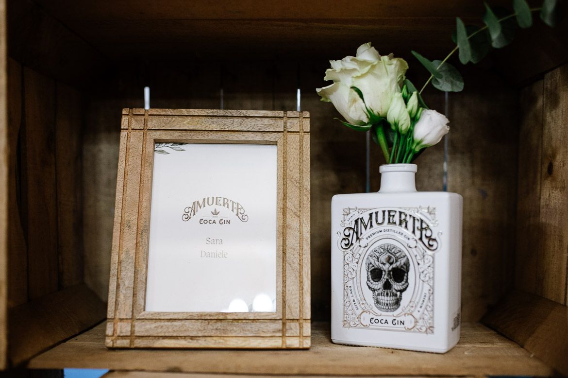 Vintage-style skull-themed glass bottles and decorative items arranged on rustic wooden shelves.