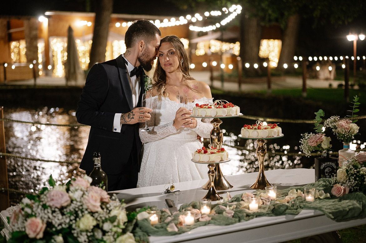An elegantly decorated wedding reception table with twinkling lights and lush floral arrangements.