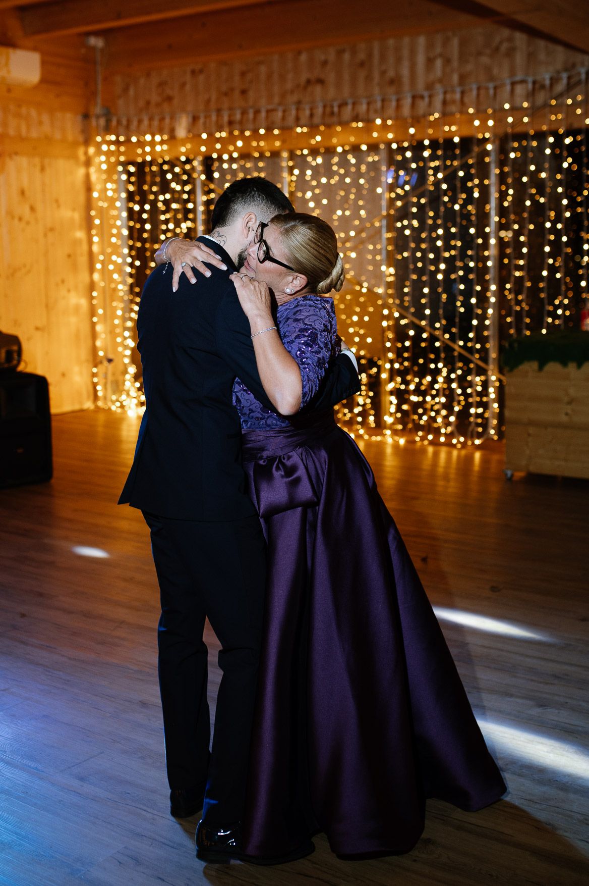 Wedding dance featuring a purple gown twirling against a backdrop of golden fairy lights.