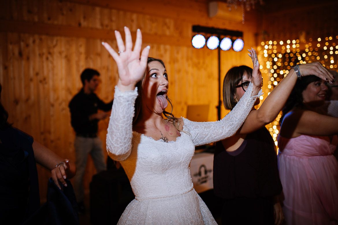 Wedding reception dance floor illuminated by string lights creates a warm, romantic atmosphere.