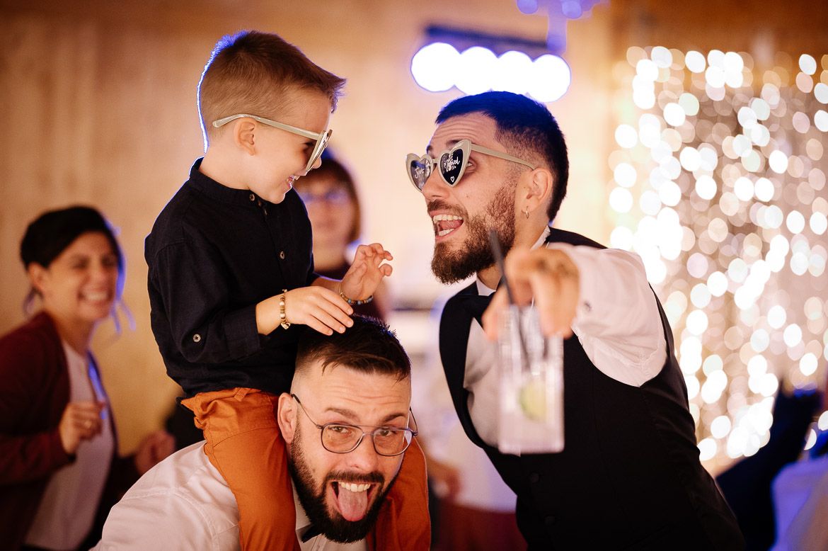 A collage of candid dance floor moments at a wedding reception with sparklers and colorful lighting effects.